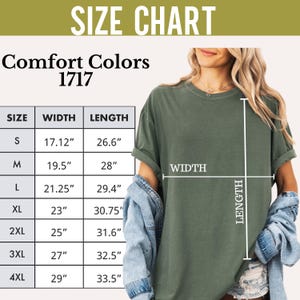 May include: Size chart for a t-shirt in sizes S to 4XL. The chart shows the width and length of the shirt in inches. The shirt is shown on a model wearing a green t-shirt.