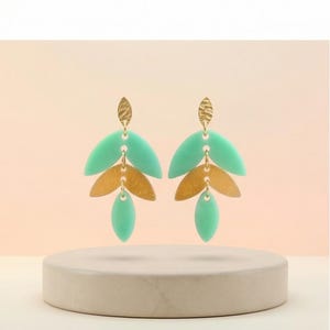 May include: A square, white ceramic soap dish with a raised, textured surface. The dish has a slightly curved shape and is designed to hold a bar of soap. The soap dish is clean and simple.