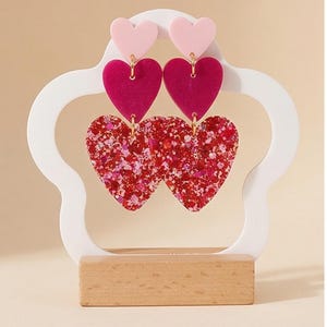 FLAVIE > Resin and glitter drop earrings with 3 pretty hearts https://www.instagram.com/capetille_jjl?igsh=MW5ueHBwcngzaXltaA