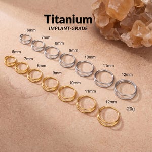 May include: A collection of silver and gold-coloured titanium implant-grade rings arranged in rows. The rings are labelled with sizes ranging from 6mm to 12mm, with a 20g gauge specification. The text Titanium IMPLANT-GRADE is visible at the top.
