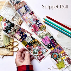 May include: A fabric snippet roll featuring a patchwork of various floral, patterned, and solid-colored textile scraps with frayed edges. The roll includes lace and crochet accents, accompanied by gold-toned scissors and three colored pencils.