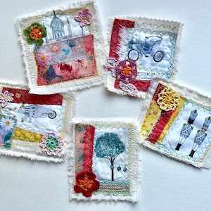 May include: Five small, square fabric art pieces with frayed edges. Each features a unique design: a mosque, a carriage, a cat on a wheel, a tree, and two toy soldiers. Embellished with crochet flowers and colourful fabric scraps.