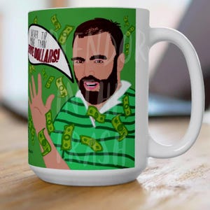 May include: White ceramic mug featuring a cartoon illustration of a man with a beard and green striped shirt, surrounded by dollar bills. Text in a speech bubble reads, "I NEVER TIP MORE THAN FIVE DOLLARS!"
