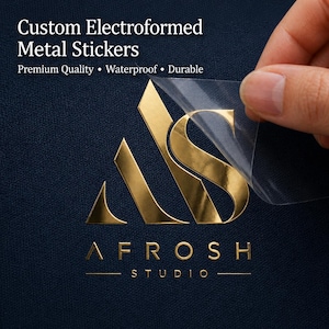 May include: Gold electroformed metal stickers with the text "Custom Electroformed Metal Stickers" and "Premium Quality • Waterproof • Durable". The stickers feature a logo and the text "AFROSH STUDIO" in gold.
