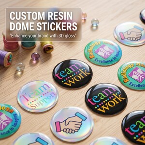May include: Round custom resin dome stickers with a glossy 3D finish. Designs include a handshake icon, the text "team work" in colorful letters, and "team support" with a dotted line. Some stickers feature "Radiology Excellence in Imaging" text.