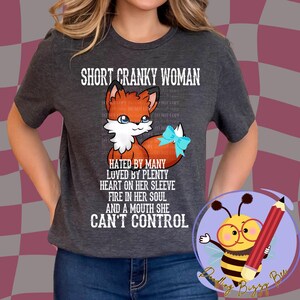 May include: Gray t-shirt with a graphic of a red fox with a blue bow. The text on the shirt reads "Short Cranky Woman Hated by Many Loved by Plenty Heart on Her Sleeve Fire in Her Soul And a Mouth She Can't Control."