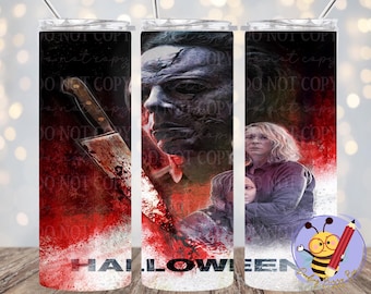 May include: A stainless steel tumbler with a Halloween design. The artwork includes a bloody knife, a scary face, and a woman with a child. The word "HALLOWEEN" is at the bottom. The tumbler has a straw.