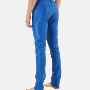 May include: Bright blue leather pants. The pants have a classic five-pocket design and a straight leg. The leather appears smooth and has a slight sheen. The pants are a vibrant shade of blue.