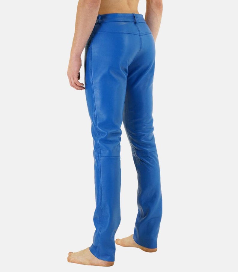 May include: Bright blue leather pants. The pants have a classic five-pocket design and a straight leg. The leather appears smooth and has a slight sheen. The pants are a vibrant shade of blue.