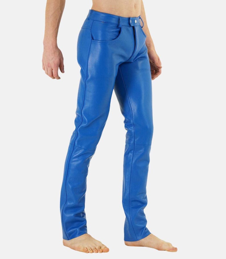May include: Bright blue leather pants with a classic five-pocket design. The pants have a button and zipper closure and are form-fitting. The leather appears smooth and has visible stitching details. The pants are a vibrant, solid color.