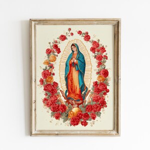 May include: Framed art print featuring a watercolor illustration of a religious figure in a blue robe, surrounded by a halo and a wreath of red and orange roses. The artwork is set against a cream-colored background.