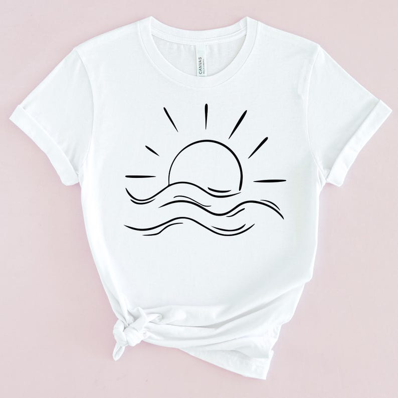 May include: White t-shirt with a black line drawing of a sun setting over waves.