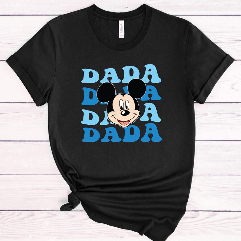 May include: Black t-shirt with a blue and white graphic of Mickey Mouse's face and the word "DADA" repeated four times.