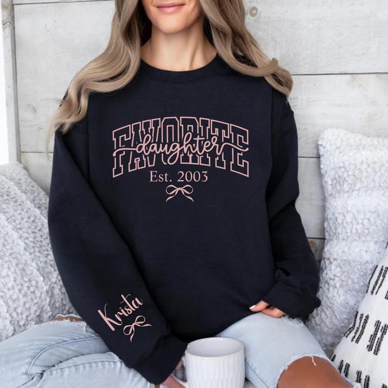 favorite daughter sweatshirt for mom, personalized daughter est year shirt with custom name on sleeve, varsity style mom sweatshirt black white pink print options, mother daughter gift sweatshirt, mom of daughters cozy apparel aesthetic