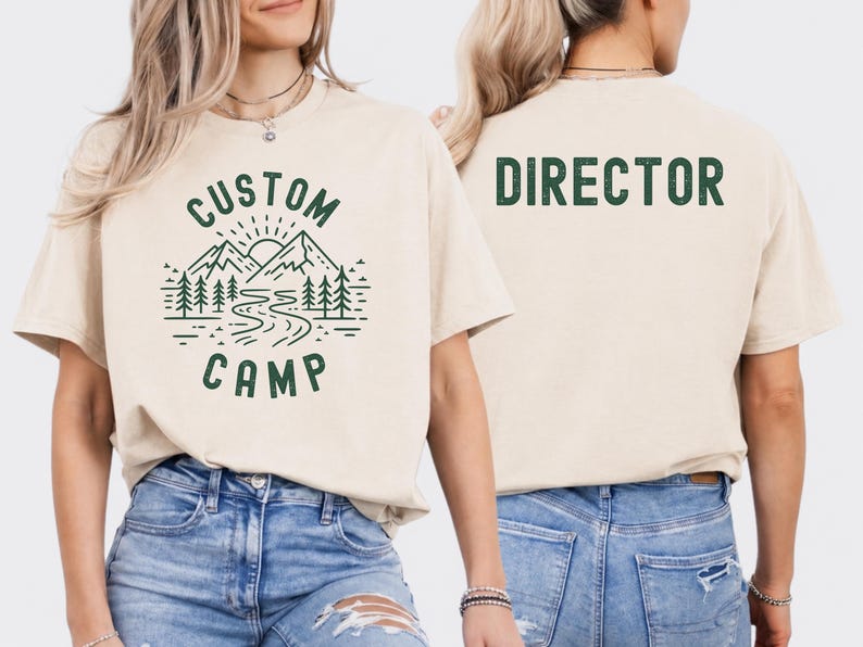 Custom Camp Shirt With Mountain Landscape And River Design On Front And Camper Text On Back, Personalized Camping T Shirt For Family And Group Trips, Ideal Outdoor Adventure Shirt For Hiking And Nature Activities.