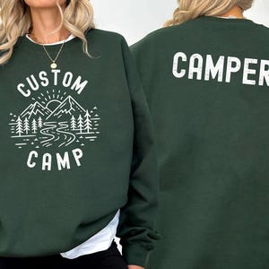 Personalized Camping Shirt With Outdoor Landscape Featuring Mountains And Trees On Front And Camper Text On Back, Custom Family Trip T Shirts Perfect For Nature Lovers And Camping Adventure Wear.