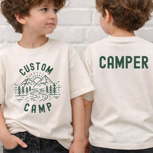 Custom Camping Shirt Featuring Outdoor Nature Landscape With Mountains And Trees On Front And Camper Design On Back, Personalized Family Trip T Shirts Ideal For Hiking, Camping And Outdoor Adventure Wear.