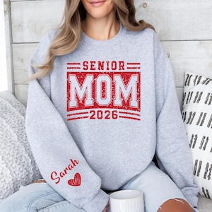 Senior Mom Shirt, Senior Mom 2026 Sweatshirt, Class of 2026 Mom Shirt, Graduation Mom Top, Personalized Sleeve Name Shirt, Senior Parent Clothing, Varsity Mom Shirt, Graduation Support Shirt, Senior Year Mom Outfit, High School Senior Mom Tee, Class of 2026 Parent Apparel, Senior Mom Crewneck, Graduation Season Shirt, School Spirit Mom Shirt, Custom Graduation Clothing