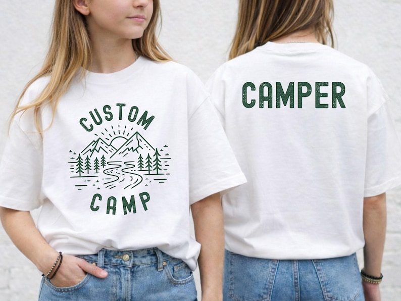 Personalized Camp Shirt With Mountain, Trees And River Design On Front And Bold Camper Text On Back, Custom Outdoor T Shirt For Family Camping Trip, Perfect For Nature Lovers And Group Adventure Outfit.