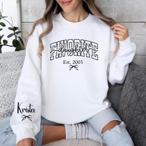 daughter sweatshirt for mom favorite daughter text, personalized est year mom shirt, sleeve name customization, mom life sweatshirt in white black and pink print, cozy aesthetic mom outfit