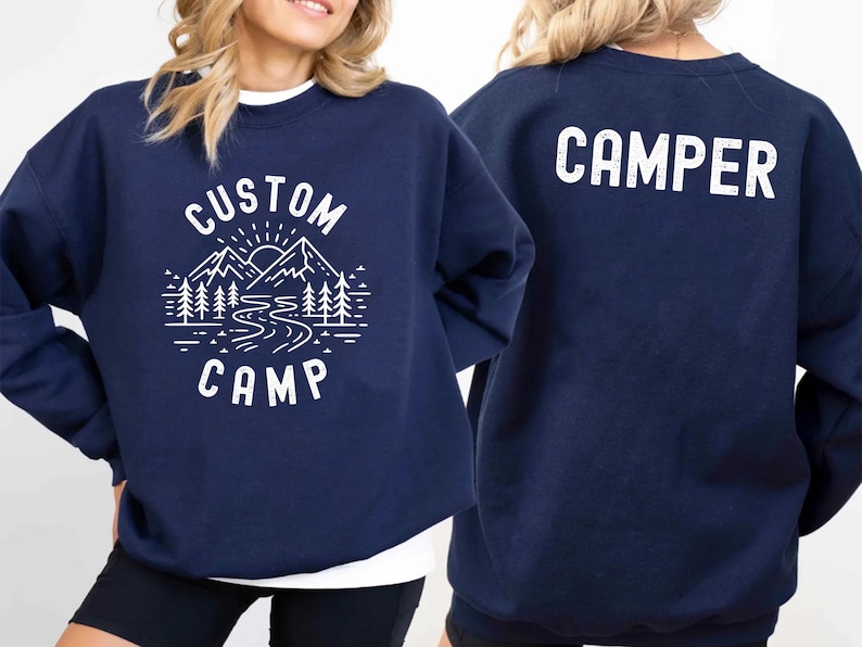 This personalized camp shirt is designed with a scenic mountain, forest, and river illustration, making it a great choice for nature lovers. Add your custom text to create a unique and memorable outfit for your camping experience.