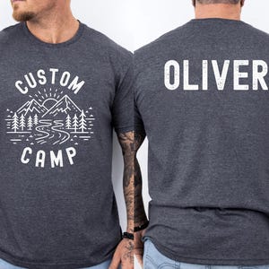 Personalized Outdoor Camp Shirt With Mountain And Forest Scene On Front And Camper Text On Back, Custom Camping T Shirt For Family And Group Trips, Ideal For Nature Lovers And Adventure Outfit.