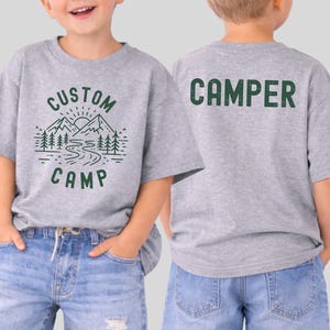 Custom Camp Shirts For Family Featuring Nature Landscape With River And Mountains On Front And Camper Back Print, Personalized Camping Trip T Shirts Perfect For Outdoor Activities And Group Travel.