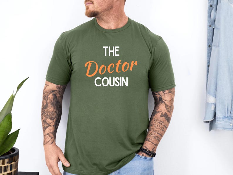 A man wearing a green t-shirt with the text "THE DOCTOR COUSIN" printed on it.