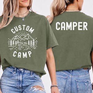 Personalized Camping Shirt Featuring Mountain And Forest Design With Custom Text On Front And Camper Print On Back, Matching Family Camping Trip T Shirts Perfect For Outdoor Adventure, Hiking, Nature Lovers And Group Camp Outfit.