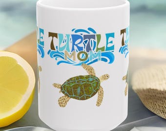 May include: A white ceramic mug featuring a graphic of a sea turtle with a green and brown patterned shell. Above the turtle, the text reads "TURTLE MOM" in blue and brown letters, surrounded by stylized blue water wave graphics.
