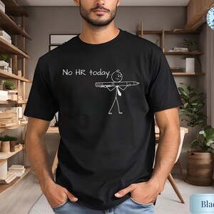 May include: Black t-shirt with the text "No HR today" and a stick figure holding a pen. The graphic is in white. The shirt is a crew neck and is being worn by a person.