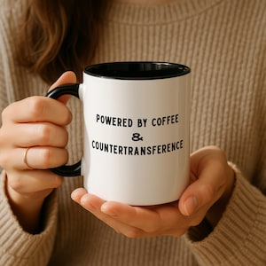 May include: A set of three ceramic mugs with a speckled, matte finish. The mugs are in shades of cream, light gray, and dark gray. Each mug has a simple, minimalist design, perfect for coffee or tea.