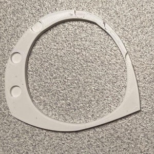 May include: Two white plastic rings with a rounded, oval shape. Each ring has three small holes on the side.