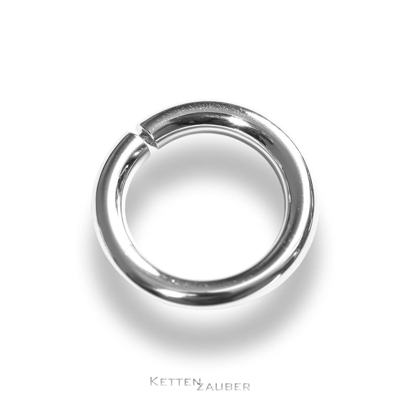 May include: A silver seamless ring, a type of jewelry used for body piercings.