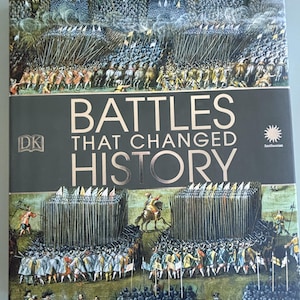 May include: A hardcover book titled "Battles That Changed History" with illustrations of historical battles. The cover features a dark gray background with gold lettering and images of soldiers in battle. The DK and Smithsonian logos are visible.