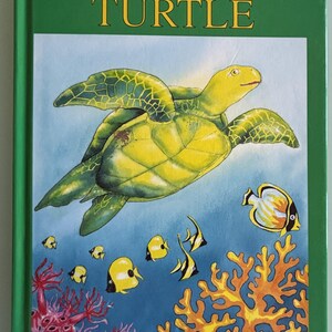 May include: A children's book cover titled "The Brave Little Turtle" with a green border. The illustration features a yellow turtle swimming above colorful fish and coral in a blue ocean setting.