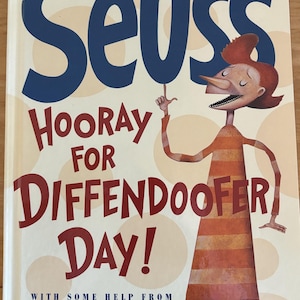 May include: A book cover with a red and white striped character with a long nose and a big smile. The book title is "Hooray for Diffendoofer Day!" by Dr. Seuss with some help from Jack Prelutsky & Lane Smith.