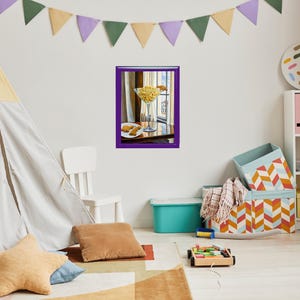 May include: A framed painting of a still life featuring a glass martini glass filled with yellow corn kernels, a plate with two small pastries, and a purple table.
