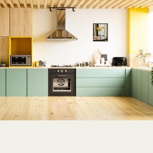 May include: A modern kitchen with light green cabinets, wood floors, and yellow accents. The kitchen features a stainless steel range hood, a black oven, and a microwave.