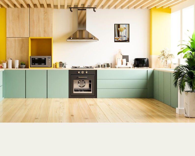 May include: A modern kitchen with light green cabinets, wood floors, and yellow accents. The kitchen features a stainless steel range hood, a black oven, and a microwave.