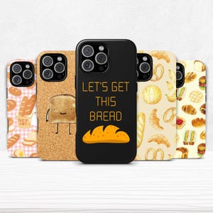 May include: A collection of phone cases with bread-themed designs. One case is black with the text "LET'S GET THIS BREAD" and a bread loaf graphic. Other cases feature patterns of bread, toast, and baked goods.
