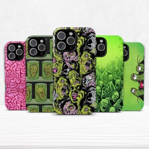 May include: Five smartphone cases with various horror-themed designs. The cases display a pink brain, zombies in jars, a collage of zombie faces, a green zombie crowd, and a green hand. The cases are designed for a smartphone.