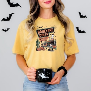 Boneyard Diner Halloween T-Shirt – Vintage Skeleton Waitress Graphic Tee for Fall, Trick or Treat, and Retro Spooky Vibes