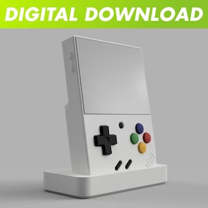 May include: A white handheld gaming device with a large screen and a base. It features a black directional pad, colored buttons, and the text "DIGITAL DOWNLOAD" in green at the top. The device has a retro design.