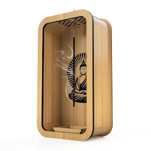 May include: A wooden incense holder with a black Buddha graphic. The holder has a rectangular shape with rounded corners and a small tray at the bottom. Incense smoke is visible inside the holder.