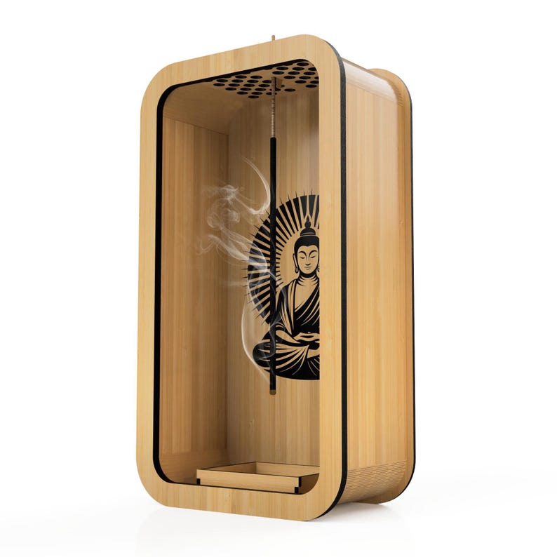 May include: A wooden incense holder with a black Buddha graphic. The holder has a rectangular shape with rounded corners and a small tray at the bottom. Incense smoke is visible inside the holder.