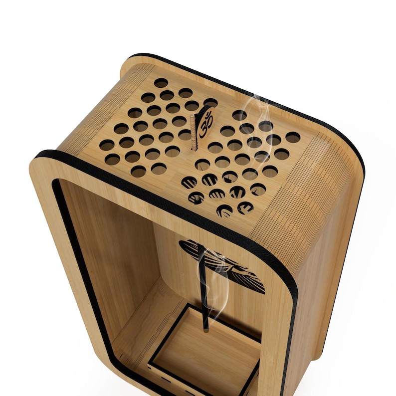 May include: A wooden aromatherapy diffuser with a light wood finish and black trim. The top has circular ventilation holes and a small, engraved symbol. Smoke is visible, rising from the interior.