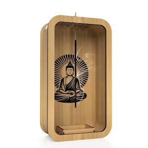 May include: A wooden incense holder with a rectangular design. The interior features a black graphic of Buddha with a radiant halo. A small tray is at the bottom, and a stick of incense is lit, producing smoke. The holder has a clear front.