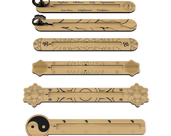 May include: A collection of wooden incense holders with various designs. Each holder is rectangular with decorative cutouts and etched patterns. Some feature text like "Emptiness" and "Inner Peace". The holders have a natural wood finish and are designed for incense sticks.