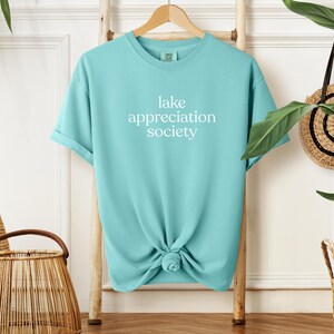 May include: A rustic wooden sign with the text "Welcome to our home" in white lettering. The sign has a distressed finish and a simple, inviting design, suitable for a front porch or entryway.